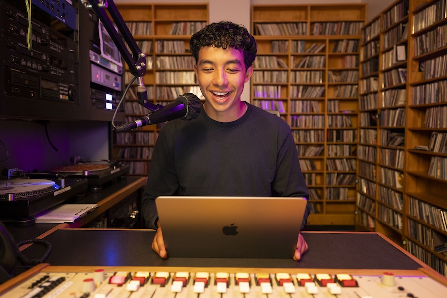 Student in recording booth with microphone